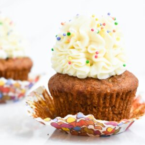 Close-up of cupcakes topped with buttercream frosting and colorful sprinkles, perfect for celebrations.